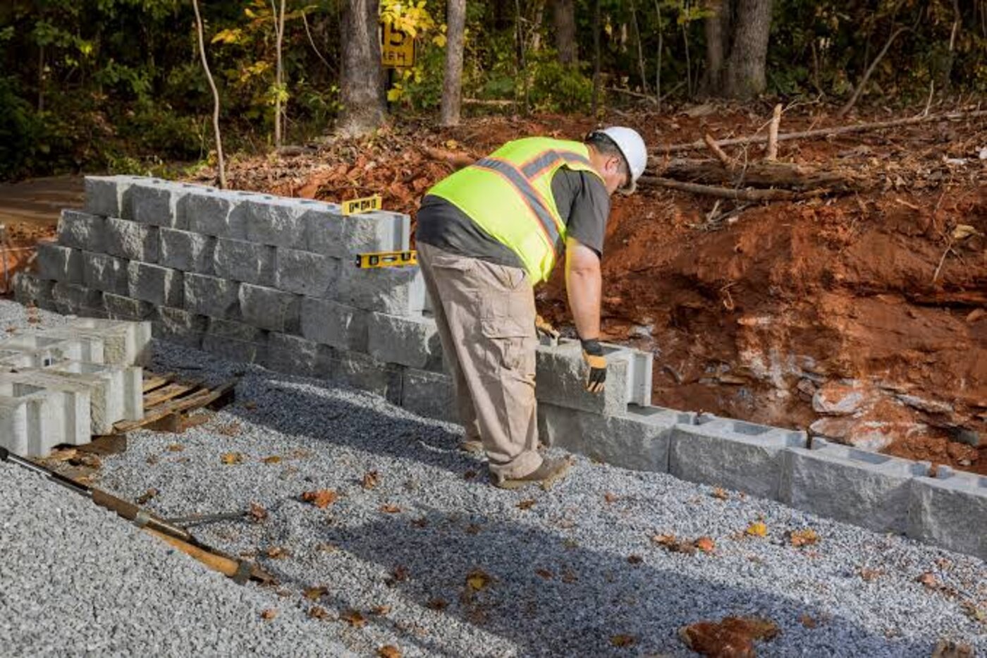 Mason building a concrete block wall at a property in Asheville, NC
