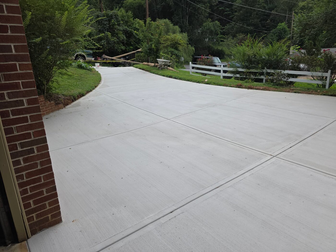 New concrete driveway and sidewalk installed in front of an Asheville, NC home